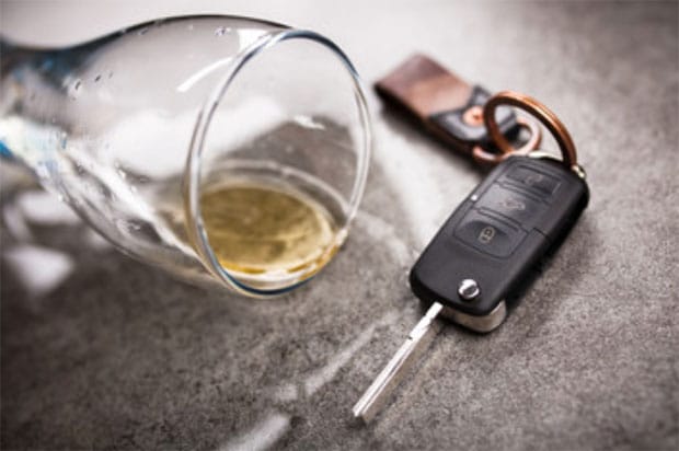 glass of alcohol with care key