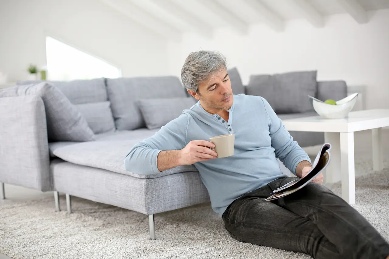 Senior Man Relaxing at Home Reading Magazine