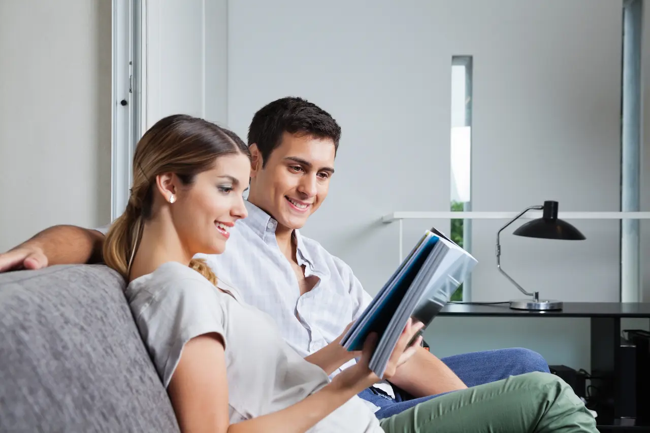 Young Women Reading Magazine While Sitting on Couch