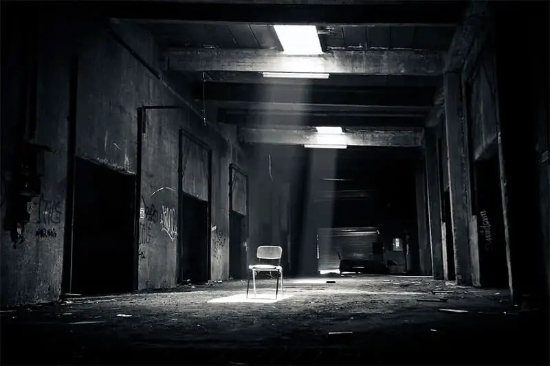 a solitary chair in an empty warehouse
