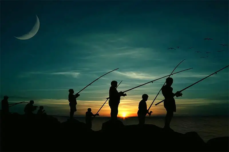 Group of shore anglers at night