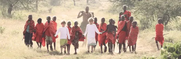 Ol Malo - Dressed in beads and Kikoys so as to fit in, two young guests walk out with their guide Hussein to experience the walk that the Samburu school children make to school each day through the African bush.